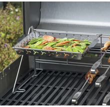 Grönsaker i en rostfri skål på en grill