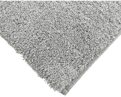 Detaljbild av en grå matta med lugg