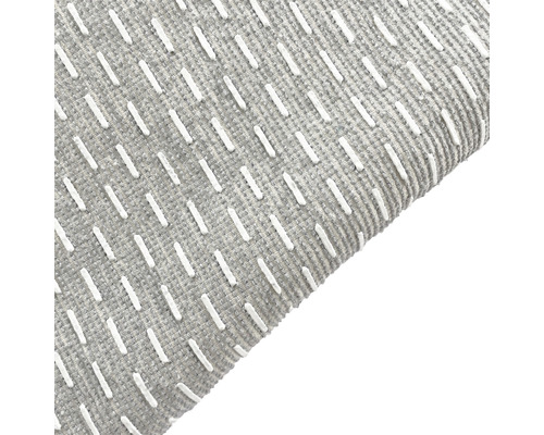 Närbild av en grå matta med mönster