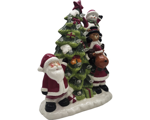 Juldekoration med jultomte, snögubbe, teddybjörn och ren bredvid en julgran med ljus