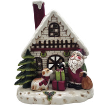 Dekorativ julscen med hus, jultomte, hund och presenter