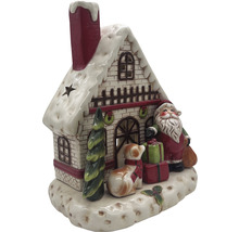 Dekorativt julhus i keramik med jultomte, hund och presenter