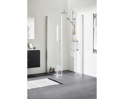 Badrum med duschkabin i glas och svart tvättställsskåp