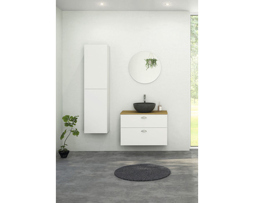 Badrum med tvättställ, spegel, högskåp och rund matta