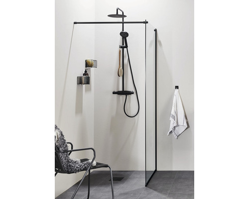 Modernt badrum med svart duschkabin, duscharmatur, förvaringshyllor och stol