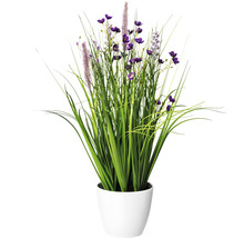 Dekorativ konstgjord växt med grönt gräs och lila blommor i en vit kruka
