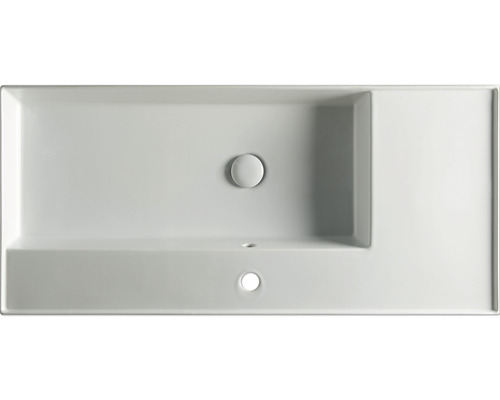 Ovanifrån av en rektangulär tvättställ i keramik med kranbänk och överflöde