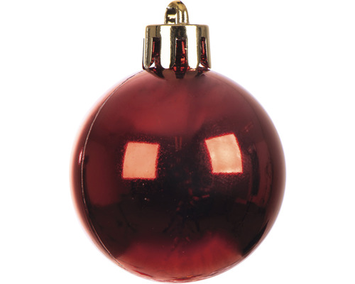 En röd julkula med guldfärgad hängare