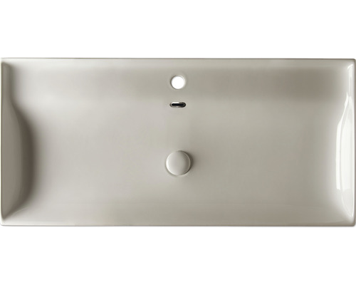 Ovanifrån visas en tvättställ med bräddavlopp och avlopp.