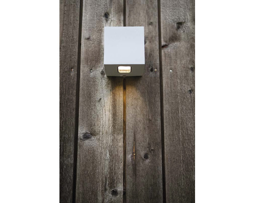 Fyrkantig utomhuslampa på en trävägg