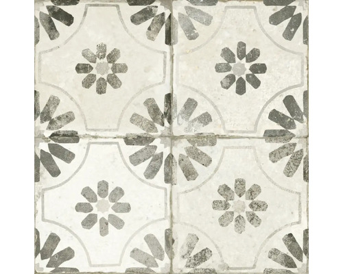 Mönster av fyra sammankopplade plattor med en geometrisk blomdesign