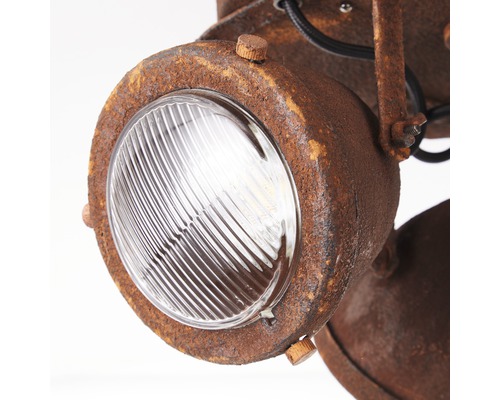 Detaljbild av en rostfärgad lampa med glasskärm