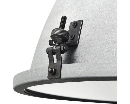 Detaljvy av en grå lampa med svart fäste och skruv