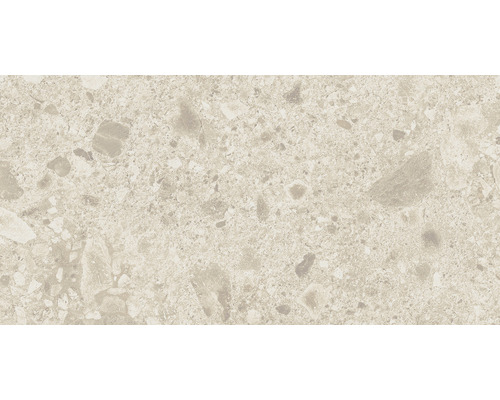 Närbild av en golvplatta med terrazzomönster.