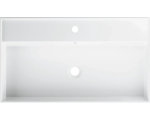 Överifrånvy av ett vitt handfat med kranhål och överfyllnadsskydd