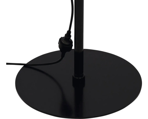 Detaljvy av foten på en golvlampa med strömkabel