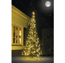 Belyst konstgjord julgran med stjärnhimmel i bakgrunden