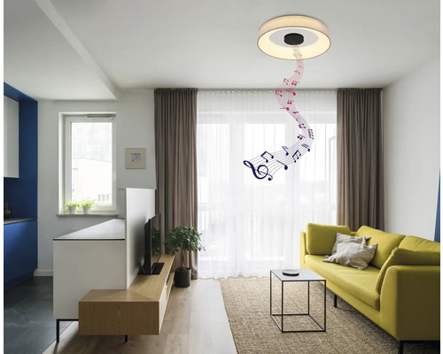 Vardagsrum med soffa, bord och taklampa med musikfunktion