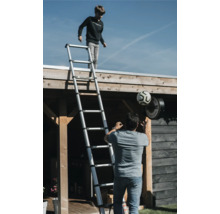 Utomhusscen med en pojke på en teleskopisk stege och en man med en fotboll.