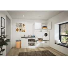 Ljust tvättrum med tvättmaskin, torktumlare, handfat och förvaringsmöbler.