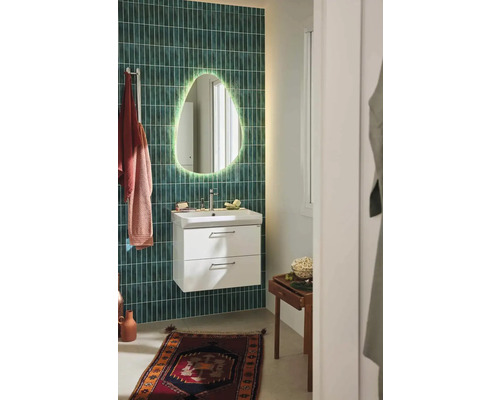 Badrum med handfatsskåp, spegel med belysning och handdukar