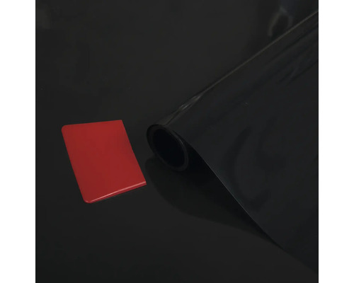 Svart film på rulle med skrapa