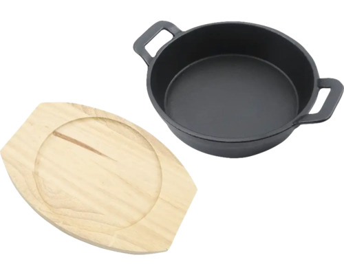 Gjutjärnspanna med underlägg av trä