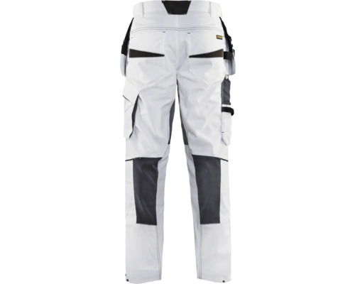 Vita arbetsbyxor med fickor och mörka förstärkningar