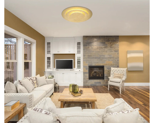 Vardagsrum med soffgrupp, soffbord, öppen spis och taklampa