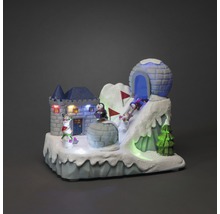 Dekorativt vinterlandskap med slott, igloo, pingviner och belysning