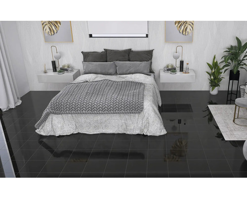 Sovrum med säng, sängbord och glänsande klinkergolv