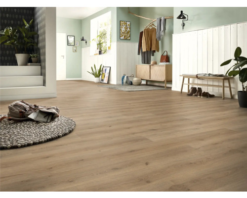 Ljus entré med laminatgolv, garderob och dekorativa element för en vänlig atmosfär.