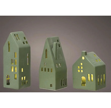 Tre dekorativa hus i keramik