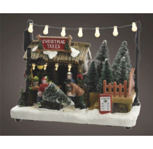 Julmarknadsscen med figurer, julgranar och belysning