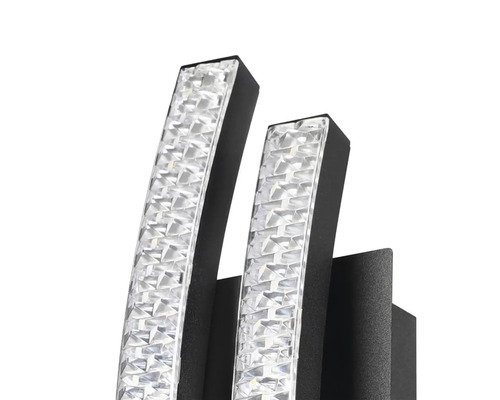 Vägglampa med två ljuselement av plast och metallelement