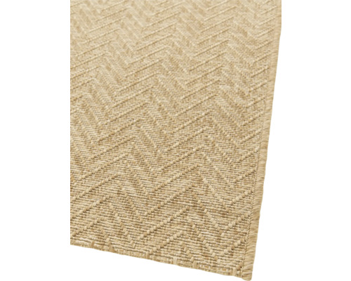 Detaljvy av en beige matta med sicksackmönster