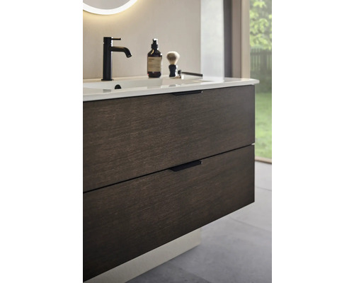 Tvättställsskåp med lådor och armatur på ett tvättställ