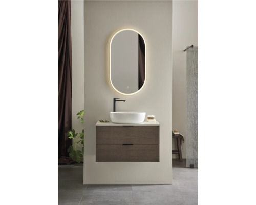 Modernt badrum med tvättställ, bänkskiva, armatur och belyst spegel