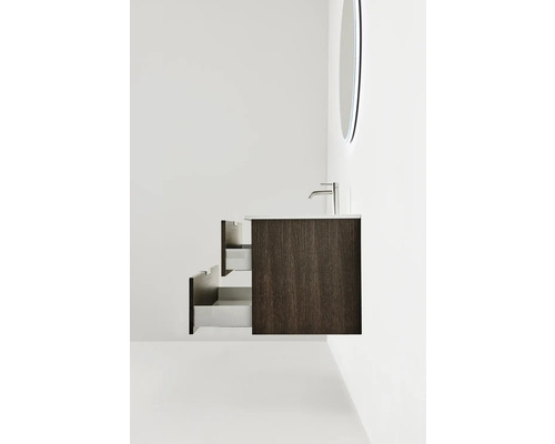 Tvättställsskåp med två öppna lådor, handfat, kran och spegel i badrummet.