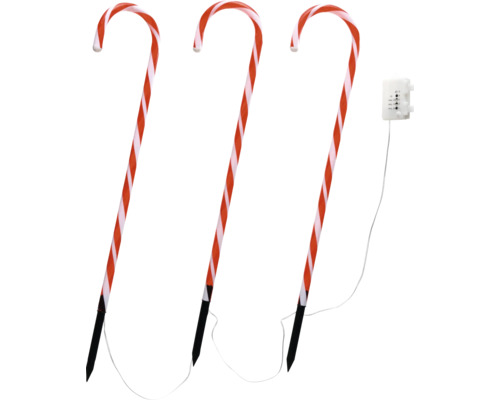 Tre röd-vitrandiga polkagrisar med jordspett och kabel för utomhusbruk.