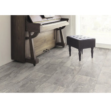 Scen med piano, pall och grått golv med marmorlook