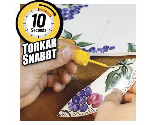 Snabbhärdande lim används för att reparera en trasig bit keramik med fruktmönster.