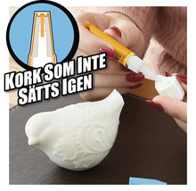 Applicering av lim på en keramisk figur i form av en fågel