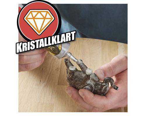 Applicering av universallim på en djurfigur. Symbol för hög vidhäftningsförmåga.